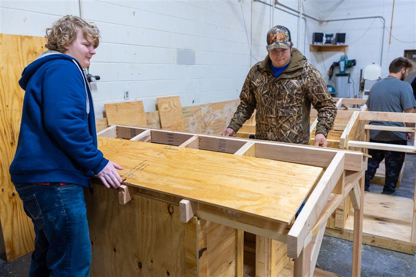 Students build doghouses